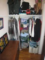 organized walk-in closet space with dresser in it and stuff put away